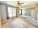 Grey living room featuring a ceiling fan and a large window at 2231 Colfax Ln, Indianapolis, IN 46260
