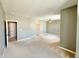 Spacious living room featuring neutral carpeting, ceiling fan, and two doorways at 2231 Colfax Ln, Indianapolis, IN 46260