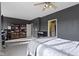 Spacious primary bedroom with modern dark walls, ceiling fan, and abundant natural light from several windows at 2231 Colfax Ln, Indianapolis, IN 46260