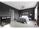 Stylish bedroom featuring dark walls, a comfortable bed, and modern furnishings at 2231 Colfax Ln, Indianapolis, IN 46260