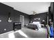Stylish bedroom featuring dark walls, a comfortable bed, and modern furnishings at 2231 Colfax Ln, Indianapolis, IN 46260