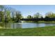 Pond with a fountain is surrounded by lush landscaping in this beautiful community at 2231 Colfax Ln, Indianapolis, IN 46260