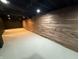 Finished basement with wood-paneled accent wall and neutral flooring at 2421 E 11Th St, Indianapolis, IN 46201