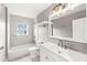 Updated bathroom with modern fixtures, vanity, and tiled bathtub at 2421 E 11Th St, Indianapolis, IN 46201