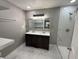 Updated bathroom with double vanity, marble shower, and modern fixtures at 2421 E 11Th St, Indianapolis, IN 46201