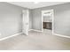 Bedroom with gray walls, flooring, and open door to bathroom at 2421 E 11Th St, Indianapolis, IN 46201
