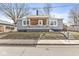 Charming gray home featuring a covered porch with decorative ironwork and beautiful stained wood at 2421 E 11Th St, Indianapolis, IN 46201