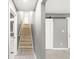 Hallway view features wooden stairs and a barn door to the living room at 2421 E 11Th St, Indianapolis, IN 46201