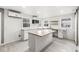 Bright kitchen featuring an island, white cabinets, a microwave, and lots of natural light from surrounding windows at 2421 E 11Th St, Indianapolis, IN 46201