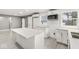 Modern kitchen with white cabinets, quartz countertops, stainless steel appliances, and updated lighting fixtures at 2421 E 11Th St, Indianapolis, IN 46201