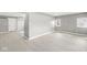 Spacious room with light gray walls, hardwood floors, and a view of the entrance and exterior windows at 2421 E 11Th St, Indianapolis, IN 46201
