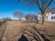 Large backyard with mature trees and a view of neighboring houses at 3143 Shadow Lake Dr, Indianapolis, IN 46217
