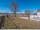 Backyard view with deck, white fence, and a pond in the distance at 3143 Shadow Lake Dr, Indianapolis, IN 46217