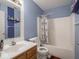 Bathroom with a shower/tub combo and wood vanity at 3143 Shadow Lake Dr, Indianapolis, IN 46217