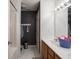 Bathroom with double sinks, a shower, and dark-colored walls at 3143 Shadow Lake Dr, Indianapolis, IN 46217