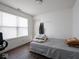 Bright bedroom with a window, gray bedding, and dark hardwood floors at 3143 Shadow Lake Dr, Indianapolis, IN 46217