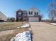 Two-story brick house with a large driveway and landscaped yard at 3143 Shadow Lake Dr, Indianapolis, IN 46217