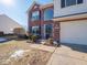 Two-story home with a red brick front, a covered entryway, and a well-manicured yard at 3143 Shadow Lake Dr, Indianapolis, IN 46217