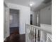 Upper level hallway with hardwood floors and multiple doors at 3143 Shadow Lake Dr, Indianapolis, IN 46217