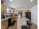 Modern kitchen with light wood cabinets and black appliances at 3143 Shadow Lake Dr, Indianapolis, IN 46217