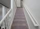 Carpeted staircase with a classic white railing at 3143 Shadow Lake Dr, Indianapolis, IN 46217