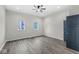 Bright bedroom with gray flooring and two windows at 350 E Minnesota St, Indianapolis, IN 46225