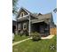 Charming two-story home with gray siding, natural wood accents, inviting front porch, and landscaped yard at 350 E Minnesota St, Indianapolis, IN 46225