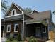 Charming gray two-story home featuring wood accents, shutters, flower boxes and a cozy front porch at 350 E Minnesota St, Indianapolis, IN 46225