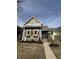 Charming two-story home featuring gray siding, decorative wood shutters, and a classic covered front porch at 350 E Minnesota St, Indianapolis, IN 46225