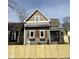 Two-story home with gray siding, decorative wood shutters, and a quaint covered front porch at 350 E Minnesota St, Indianapolis, IN 46225