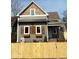 Charming two-story home featuring gray siding, decorative wood shutters, and a classic covered front porch at 350 E Minnesota St, Indianapolis, IN 46225