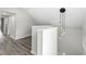 Upstairs hallway with modern light fixture and wood-look flooring at 350 E Minnesota St, Indianapolis, IN 46225