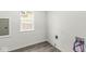 Laundry room with wood-look vinyl flooring and space for a washer and dryer at 350 E Minnesota St, Indianapolis, IN 46225