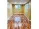 Spacious basement featuring laminate flooring, neutral paint, and natural light from two windows at 4114 N Butler Ave, Indianapolis, IN 46226