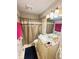 Bathroom features a vanity, an updated light fixture and a shower-tub combo at 4114 N Butler Ave, Indianapolis, IN 46226