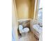 Half bathroom featuring tiled accent wall, tile flooring, and a window for natural light at 4114 N Butler Ave, Indianapolis, IN 46226
