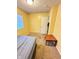Bedroom featuring yellow walls, carpet flooring, and a window with blinds at 4114 N Butler Ave, Indianapolis, IN 46226