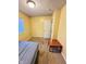 Bedroom featuring yellow walls, carpet flooring, and a window with blinds at 4114 N Butler Ave, Indianapolis, IN 46226