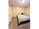 Bedroom featuring yellow walls, carpet flooring, and a window with blinds at 4114 N Butler Ave, Indianapolis, IN 46226
