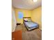 Bedroom featuring yellow walls, carpet flooring, and a window with blinds at 4114 N Butler Ave, Indianapolis, IN 46226