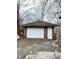 Exterior of a brick one-car garage featuring a white garage door and side entrance at 4114 N Butler Ave, Indianapolis, IN 46226