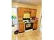 Functional kitchen includes oak cabinetry, an electric stove and great flow to the dining room at 4114 N Butler Ave, Indianapolis, IN 46226