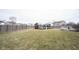 Large fenced backyard with grass, play set, and trampoline at 5782 Jamestown Square Ln, Indianapolis, IN 46234