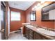 Bathroom featuring a double sink vanity with cultured marble countertop, framed mirrors and tiled floor at 5782 Jamestown Square Ln, Indianapolis, IN 46234