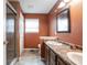 Bathroom featuring a double sink vanity, framed mirror, and walk-in glass shower at 5782 Jamestown Square Ln, Indianapolis, IN 46234