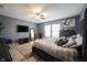 Comfortable bedroom with a ceiling fan, wood-look flooring, natural light and gray walls at 5782 Jamestown Square Ln, Indianapolis, IN 46234