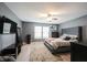 Spacious bedroom with ceiling fan, wood-look flooring, natural light and a large bed at 5782 Jamestown Square Ln, Indianapolis, IN 46234
