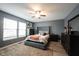 Stylish main bedroom featuring a ceiling fan, windows, and wood-look flooring at 5782 Jamestown Square Ln, Indianapolis, IN 46234