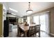 Bright, open-concept dining area with view into living room and large windows, great for entertaining at 5782 Jamestown Square Ln, Indianapolis, IN 46234