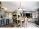 The open layout connects dining room to kitchen and living areas for seamless living and entertaining at 5782 Jamestown Square Ln, Indianapolis, IN 46234